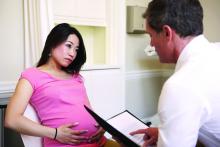 Pregnant woman talking with obstetrician